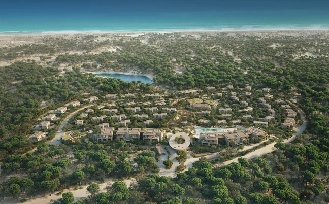 Circular resort set within lush forest, bordered by a sandy coast and blue ocean, designed to harmonize with nature and support wellness and sustainability.