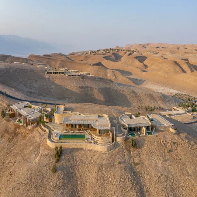 Thoughtfully designed hotel harmonizing with desert surroundings, featuring sustainable architecture and welcoming natural light.