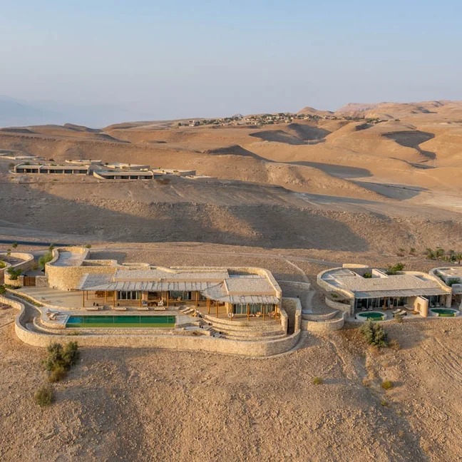 Thoughtfully designed hotel harmonizing with desert surroundings, featuring sustainable architecture and welcoming natural light.
