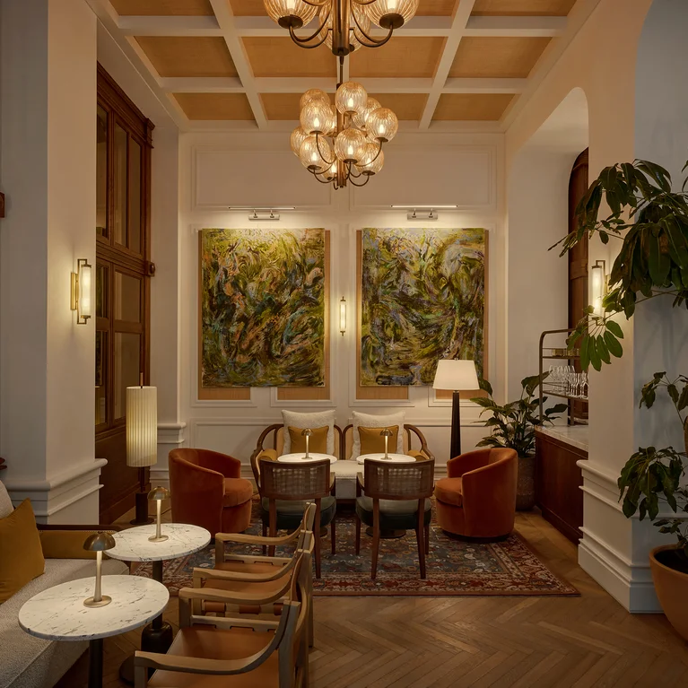 Inviting lounge featuring soft seating, round tables, contemporary lamps, leafy plants, abstract wall art and gentle lighting in a tranquil space focused on comfort and wellbeing.