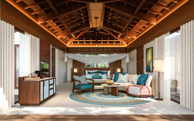 Interior de una villa con techo de madera natural, mobiliario contemporáneo, alfombra, sofá, mesa de centro, cojines mullidos, cuadros en las paredes y una zona de café; la luz del sol se cuela a través de amplios ventanales.