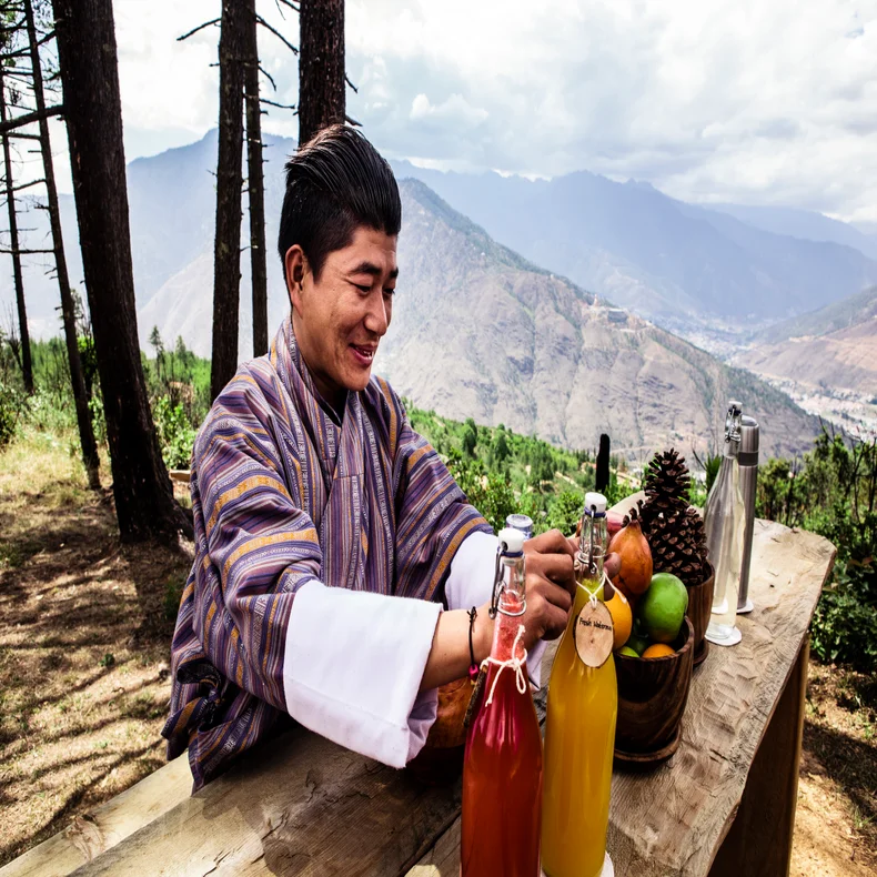 Afternoon tea with local flavors, prayer flags and pine trees at Lungsigang.