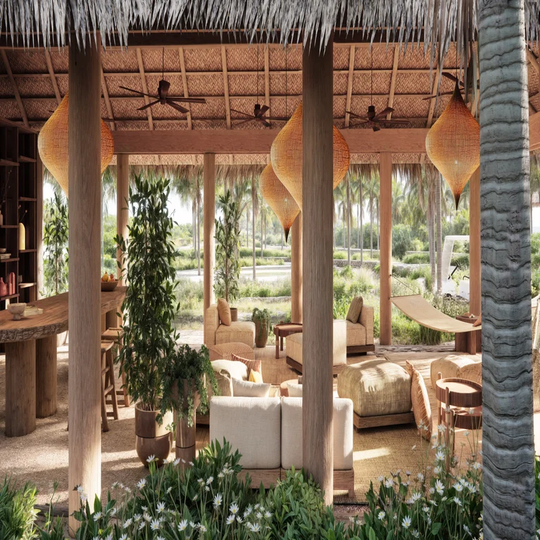 Lounge area featuring natural wood furnishings, comfortable seating, woven lighting, abundant greenery and hammock, set against tropical garden views with palm trees.