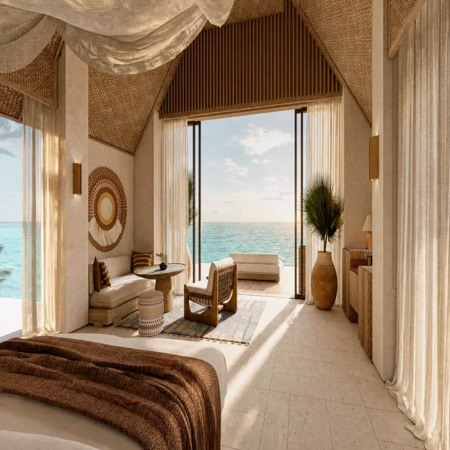 Dormitorio con puertas correderas que dan a vistas al mar, materiales naturales, detalles de tejidos y luz natural que se filtra a través de cortinas transparentes, creando un ambiente tranquilo.