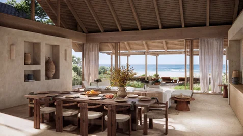 Dining and lounge space featuring natural wood furnishings, expansive windows, and views of the ocean softened by sheer curtains.